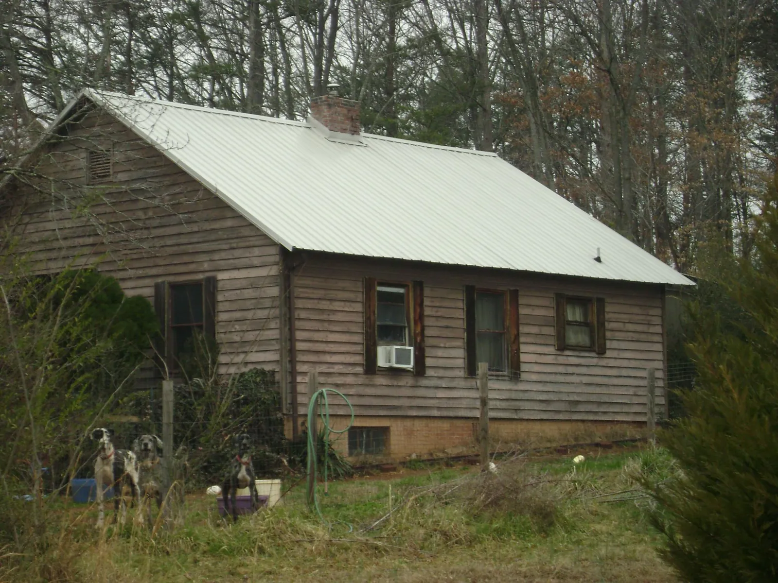 White metal roof on an old wood sided farmhouse, from a Metal Roof Installation job in Maitland