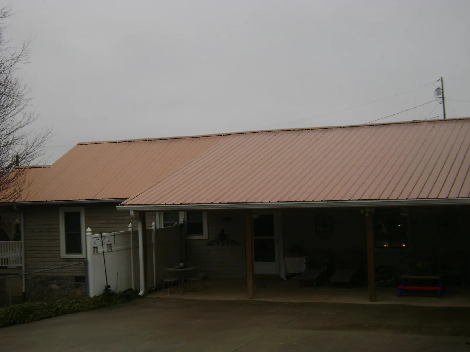 Copper toned metal roof over a wide covered patio in Maitland